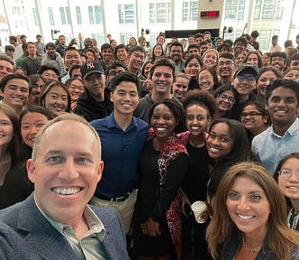 A group selfie, with Bret Taylor in the foreground and dozens of interns in the background. There’s a diverse mix of people.