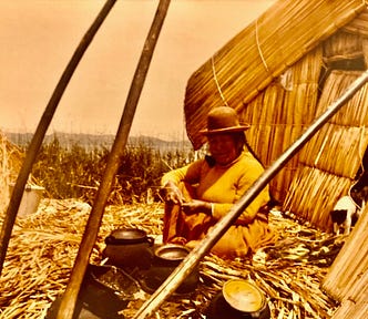 A native Indian woman sitting in front of her floating home on Lake Titicaca, Bolivia