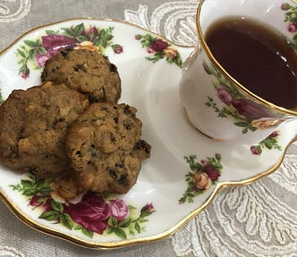 Fine english china with fruitcake cookies and tea