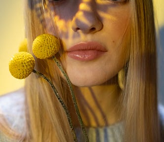 Photo of a woman with a prism of light on her face
