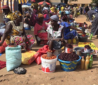 Women selling food products in an open street market