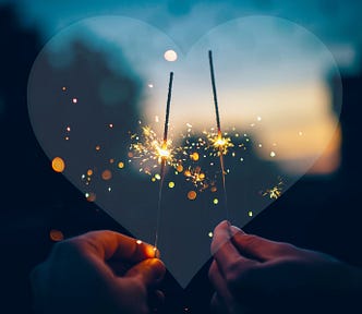 shadow heart with two hands holding sparklers