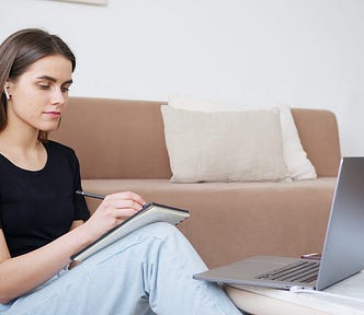 Young woman studying with her laptop at home