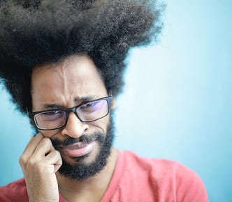 Man with glasses frowning, for my What to Do When You Don’t Know What to Write article