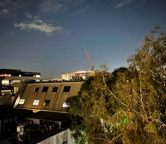 The tops of apartment buildings set against a night sky.