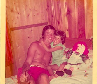 Author at age 4 with her father at their beach house in Connecticut