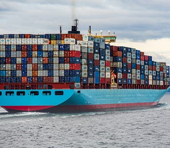 An image of a ship carrying multiple shipping containers.