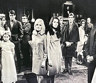 Multiple characters stand in the main room of the mansion of Dark Shadows. Gothic horror, vampire, culture, series, television, nostalgia