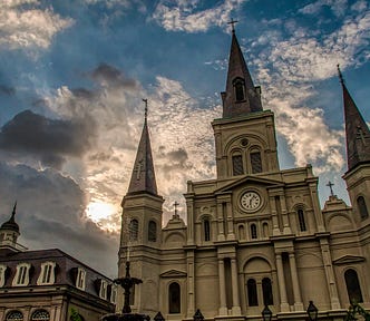 Image of Saint Louis Cathedral by Mick Haupt. Large which church and cloudy blue sky.