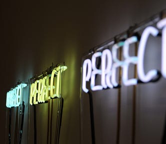 Neon signs that read “PERFECT.”