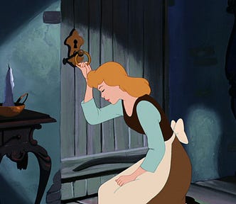 A sad blonde girl (Cinderella) in the clothing of a maid is sitting down by the locked door and holding on to the door knob. The door is locked.