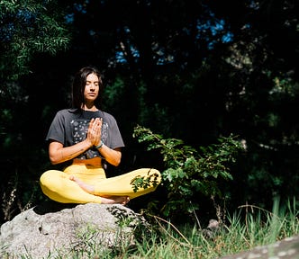 A woman meditating outdoors