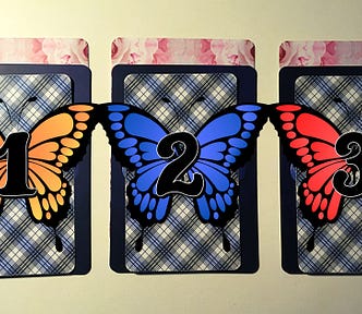 Three tarot and oracle pick a card piles with butterflies on them