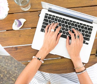 Women with nice rings typing on laptop