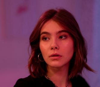 An attractive young woman, looking slightly uncertain.