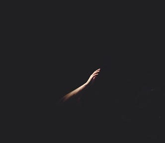 Hand reaching in the dark