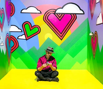 man sitting on multicolored 3d room