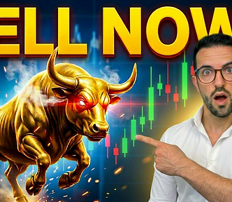 Man in white shirt pointing at a charging golden bull with glowing red eyes, with bold yellow “SELL NOW?” text overlay against a backdrop of green and red stock charts.