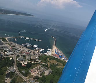 A strip of beach as seen out the window of an aircraft.