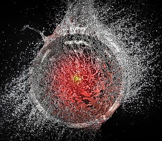 A popping water-balloon, caught mid-burst. Superimposed over it is the hostile glaring eye of HAL9000 from Stanley Kubrick’s ‘2001: A Space Odyssey.’ Image: Cryteria (modified) https://commons.wikimedia.org/wiki/File:HAL9000.svg CC BY 3.0 https://creativecommons.org/licenses/by/3.0/deed.en — tom_bullock (modified) https://www.flickr.com/photos/tombullock/25173469495/ CC BY 2.0 https://creativecommons.org/licenses/by/2.0/