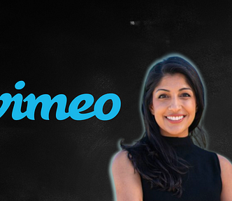 Anjali Sud standing next to Vimeo logo