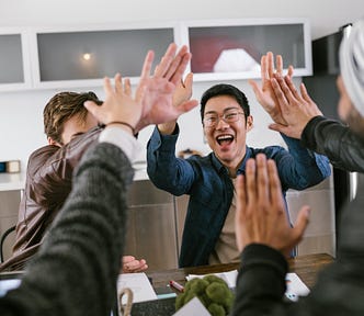 A team celebrates its success in the office