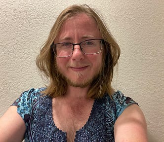 A photo of the author looking very feminine with a smile and a colorful shirt he often wore before transitioning.