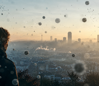 Silhouette of a person overlooking a hazy cityscape with floating microscopic particle-like structures symbolizing ultrafine air pollution and environmental health risks.