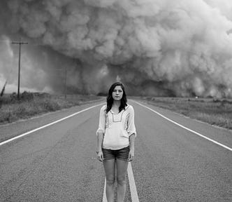 Woman in a dust storm, Photo by Morgan Sessions on Unsplash