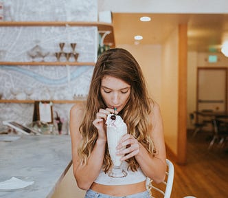 A sexy woman drinks a milkshake before masturbating in a crowded mall food court. A sexy erotica about the mall.