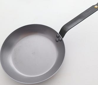 A new carbon steel pan, as seen from an angle.