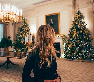 Woman surveying a room of amazing Christmas decorations she slaved over all month