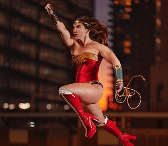 An illustration of a woman dressed like Wonder Woman, jumping from a rooftop.