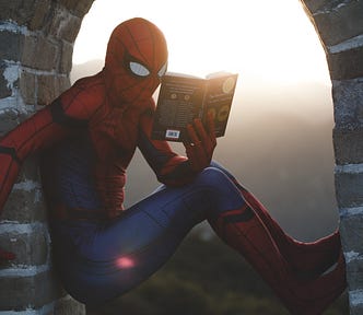 Spiderman reading The Decision Book.