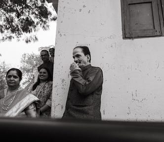 Mother and father standing teary-eyed, bidding their daughter goodbye after the wedding.