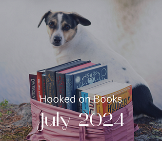 A dog sitting behind a stack of books