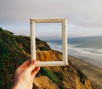 Image of a hand holding up a photo frame