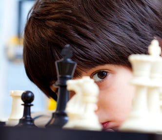 Young boy playing chess