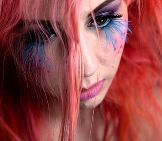 Girl with pink hair and blue eyelashes