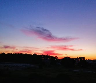 sunrise, purplish blue sky with reddish clouds