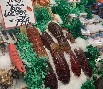 Fresh and colorful lobster tails on ice at Seattle’s Pike Place market. The price is displayed as $79.99 a pound.