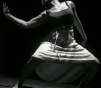 A black and white photo of a female dancer performing