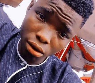 A selfie photo of Tobi, with earphones in