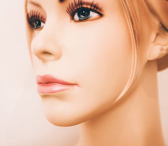 a perfectly made up woman with fake eyelashes