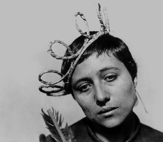 Still from The Passion of Joan of Arc. Joan looks despairing, dressed in a fake crown.