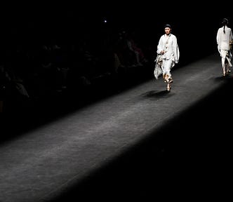 A Chinese model walks down a fashion runway