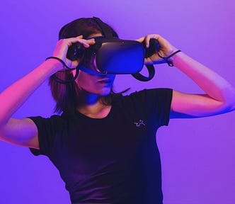 A woman leans back looking through a VR headset.