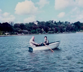 A 14-year-old boy and his father in a rowing boat on a lake in 1982