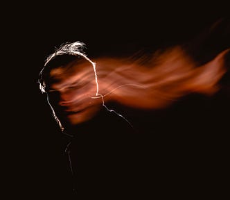 Long-exposure portrait of a man in the darkness