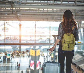 20-year-old woman waiting at airport for a flight, ready to leave home